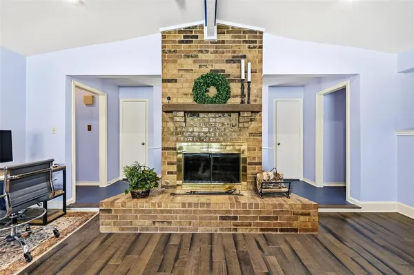 a bedroom with a bed and a fireplace