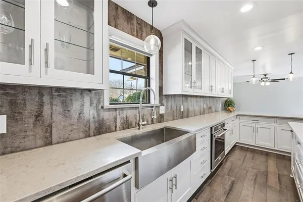 a kitchen that has a sink and a stove