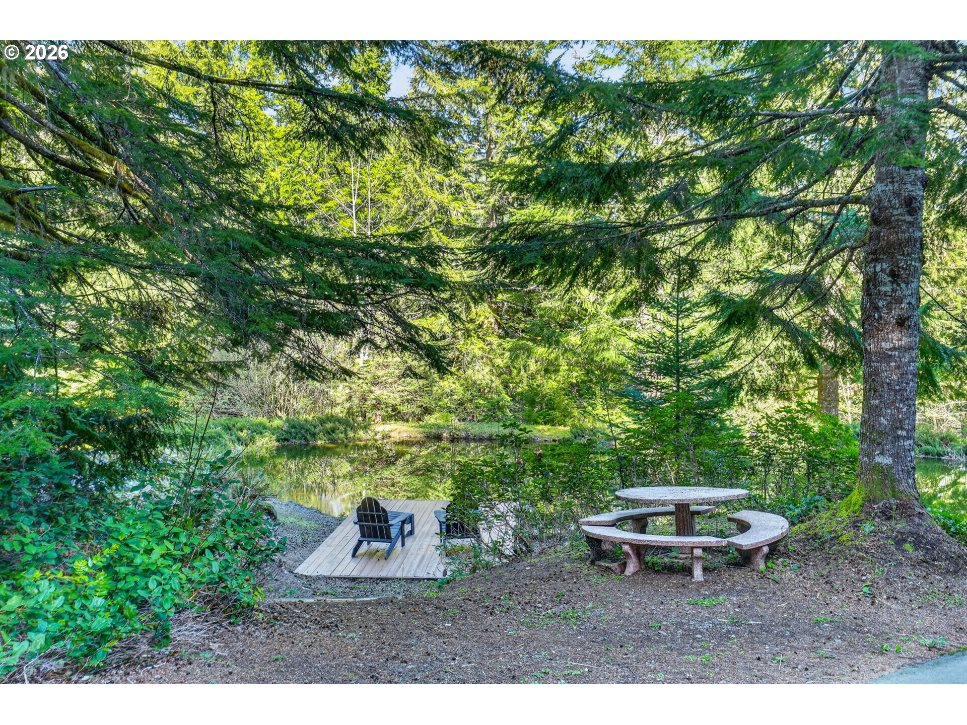 18685 East Aschoff Road Rhododendron, OR 97049 - Photo 37 of 48 a backyard of a house with table and chairs