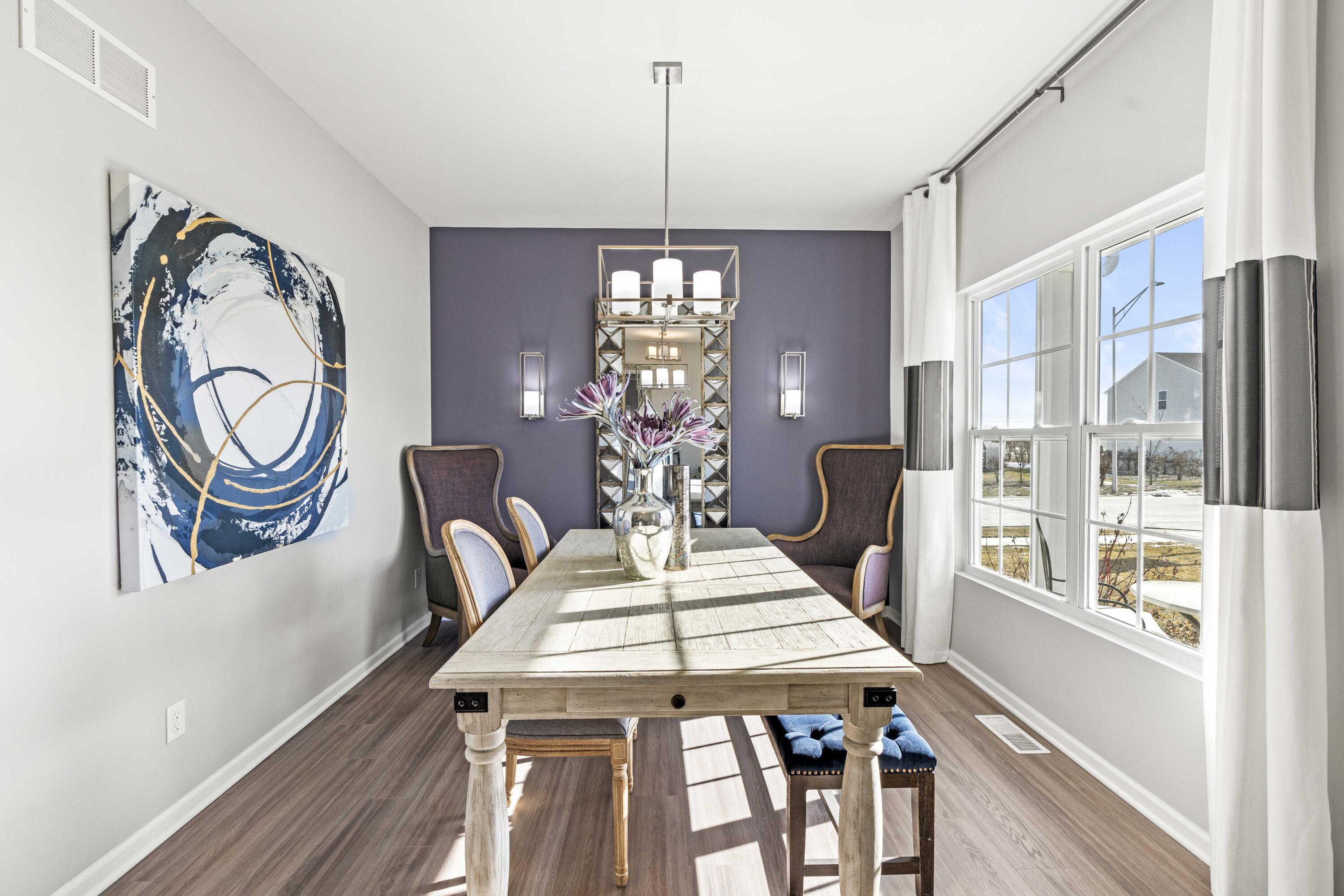6587 East 104th Avenue Crown Point, IN 46307 - Photo 2 of 18 a view of a dining room with furniture window and wooden floor