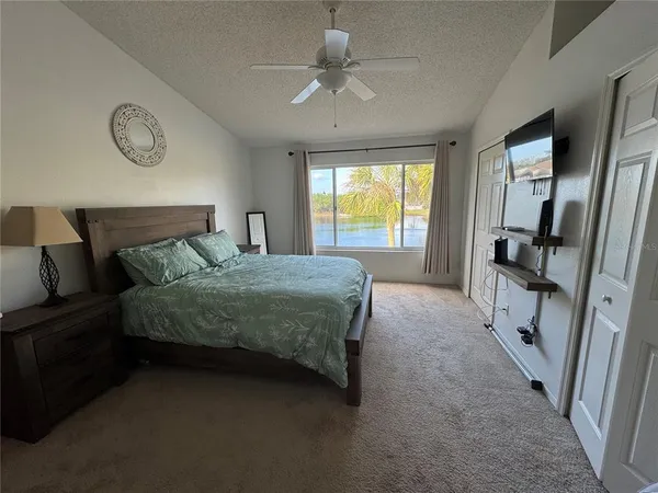 a bedroom with a large bed and a chandelier