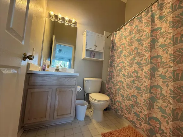 a bathroom with a toilet a sink and a mirror