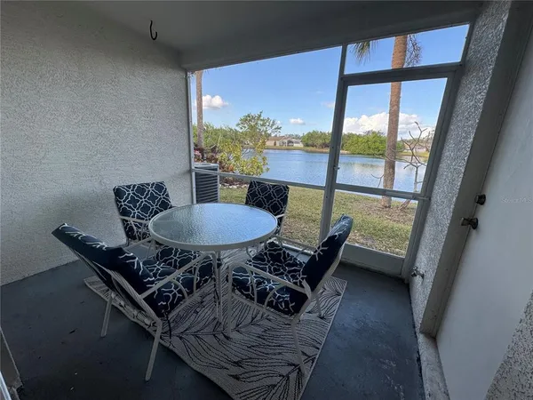 a dining room with furniture and a floor to ceiling window