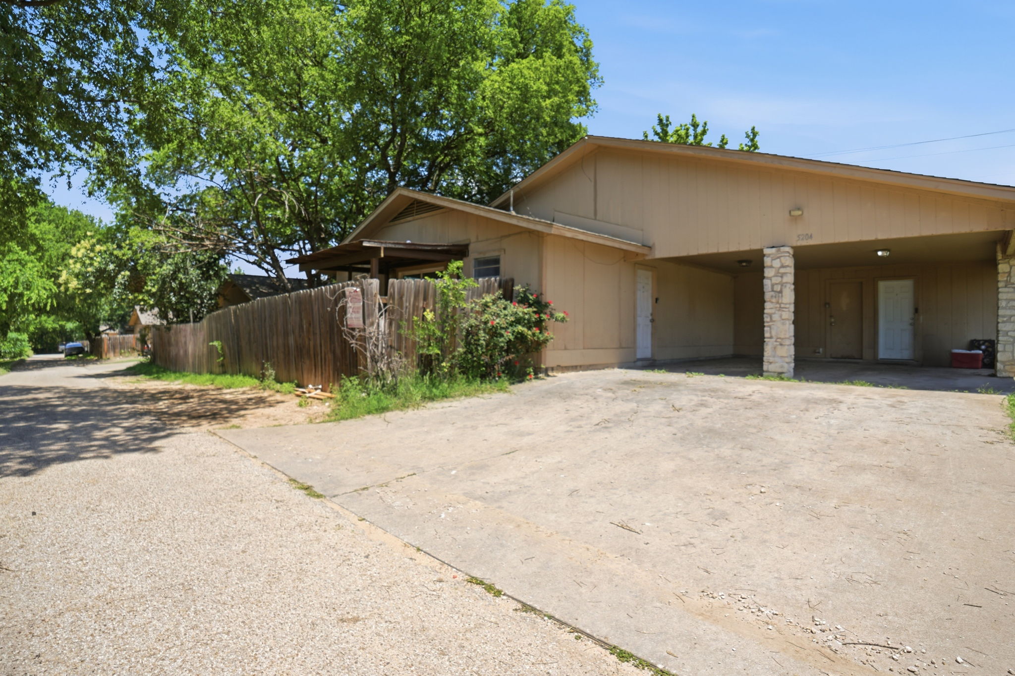 5204 Nuckols Crossing Road, Unit B Austin, TX 78744 - Photo 2 of 16 a front view of a house with a yard and garage