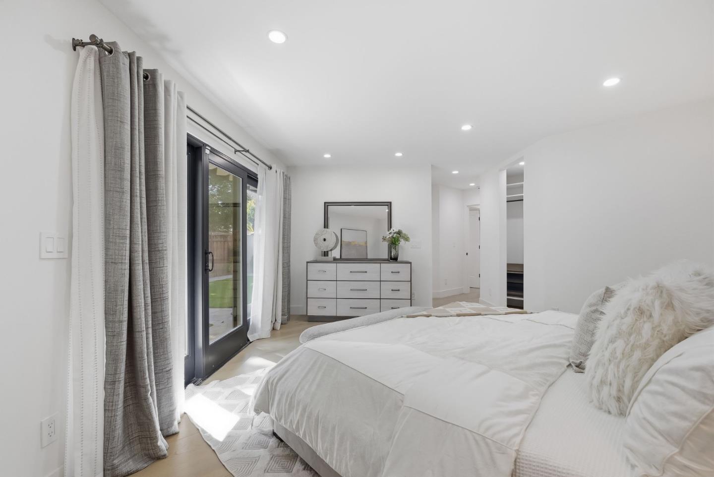845 Pollard Road Los Gatos, CA 95032 - Photo 34 of 47 a large bedroom with a bed and a large mirror