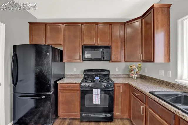 a kitchen with stainless steel appliances granite countertop a refrigerator stove and sink