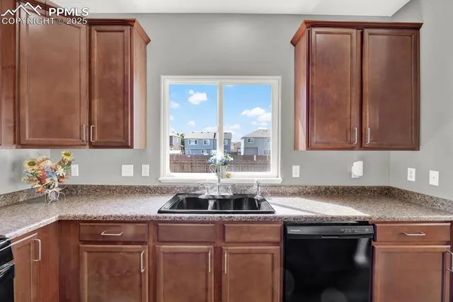 a kitchen with stainless steel appliances granite countertop a sink a counter space and cabinets