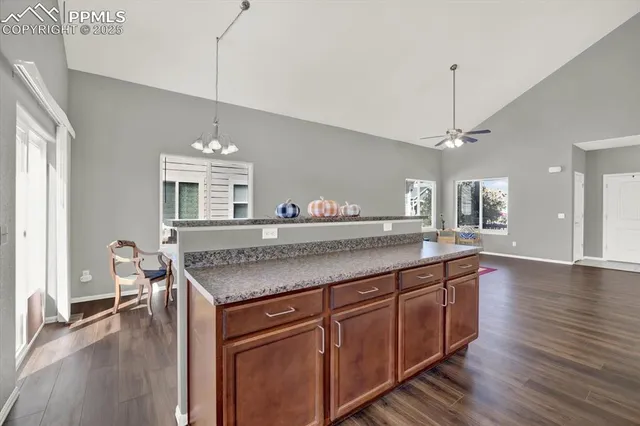 a kitchen with center island table and chairs in it