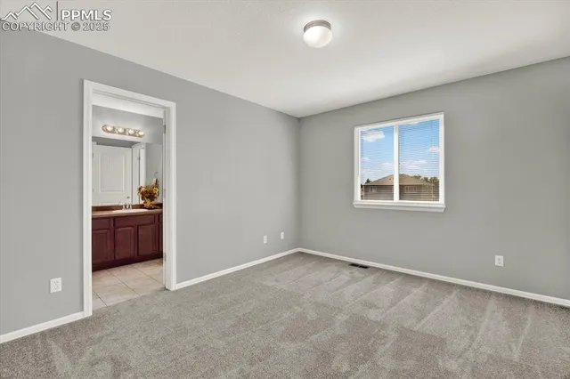 an empty room with a piano and wooden floor