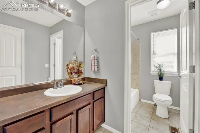 a bathroom with a sink toilet and a mirror