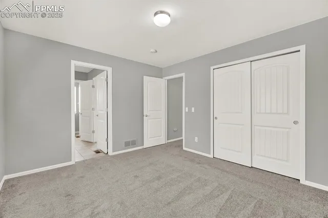 an empty room with closet area