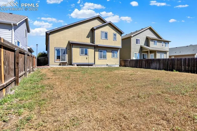 a front view of a house with a yard outdoor seating and garage