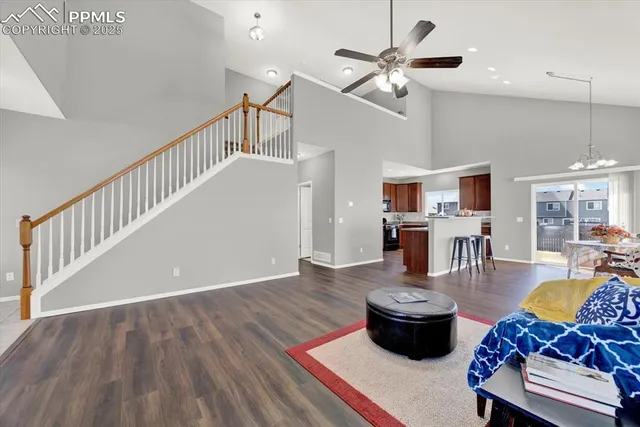 a living room with furniture and kitchen view