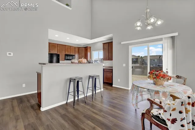 a living room with kitchen island furniture and wooden floor