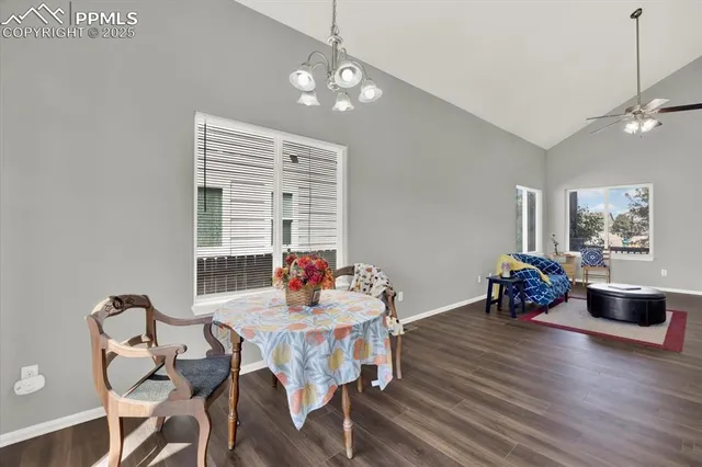 a dining room with furniture window and wooden floor