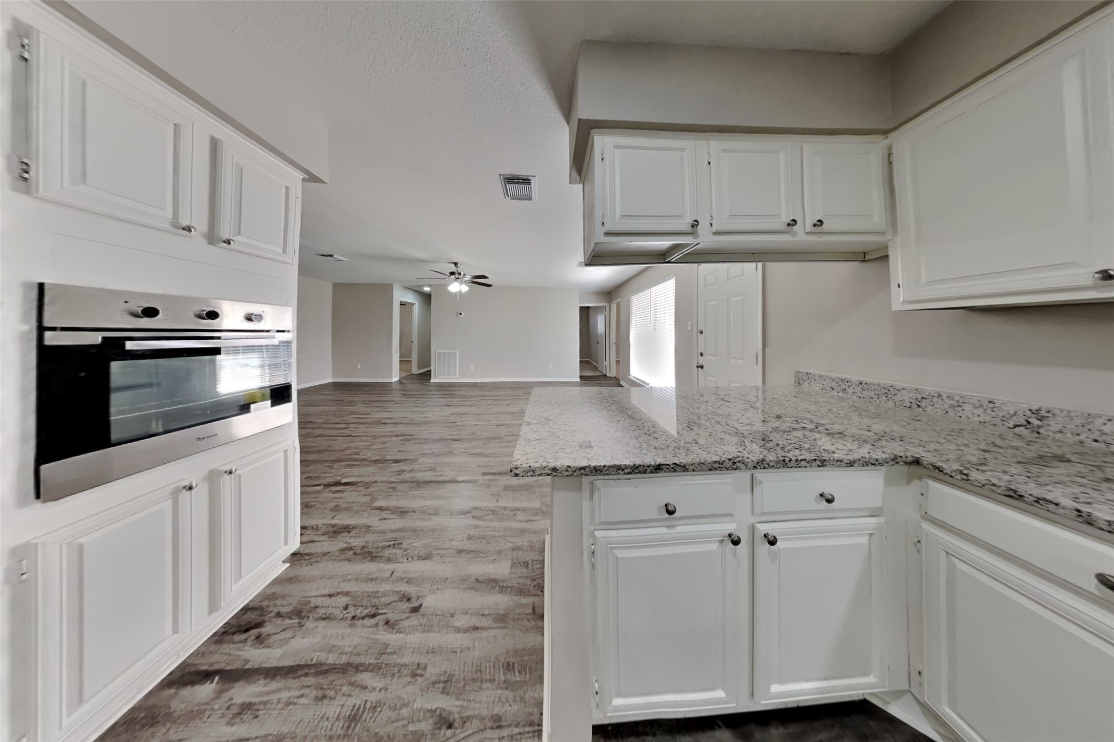 9615 Orangevale Drive Spring, TX 77379 - Photo 6 of 21 a kitchen with granite countertop white cabinets and stainless steel appliances