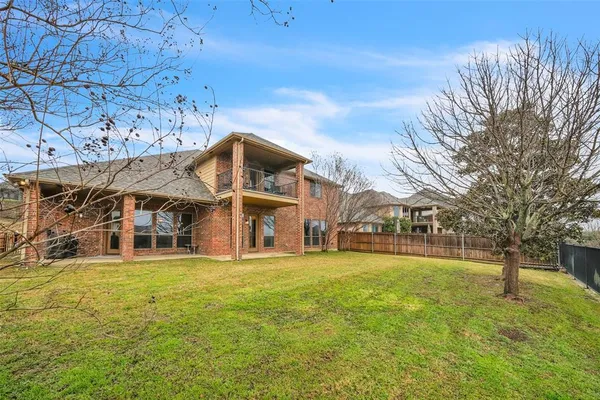 a view of a large building with a big yard and large trees