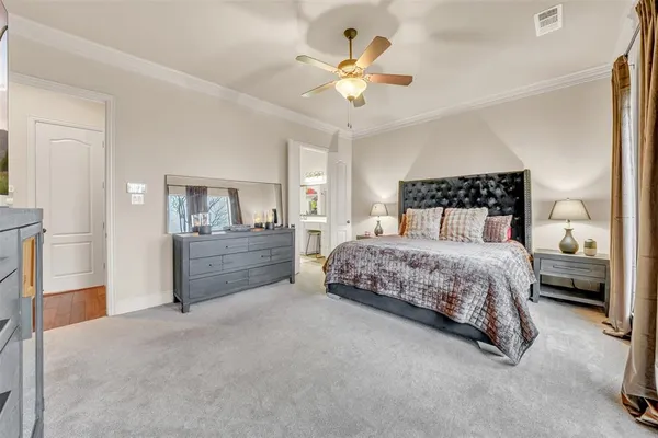 a spacious bedroom with a bed couch and a large window