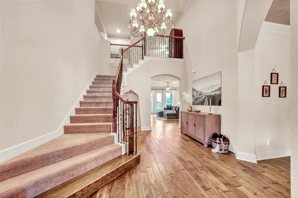 a view of entryway and hall with wooden floor