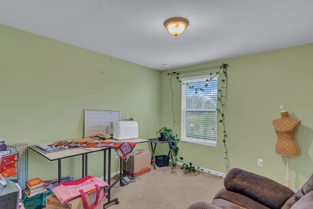 a bedroom with furniture and a window