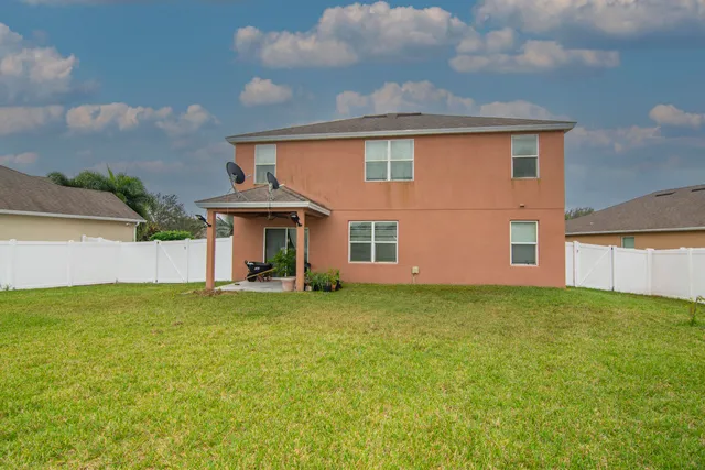 a front view of a house with a garden and yard