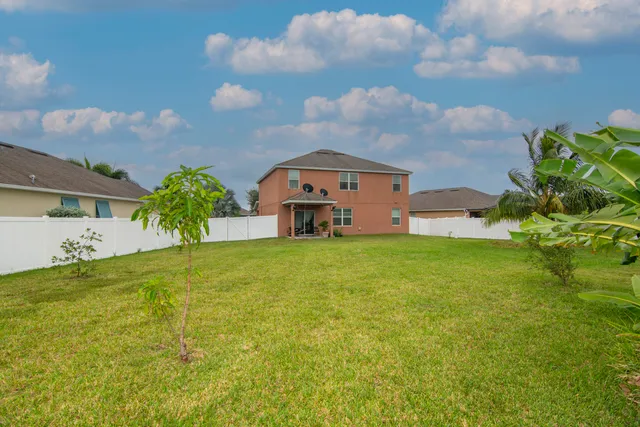 a backyard of a house with lots of green space and garden