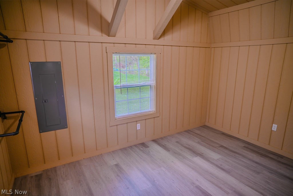 1547 Providence Road Elizabeth, WV 26143 - Photo 13 of 32 Interior space featuring vertical wood paneling walls and a vaulted ceiling with exposed beams