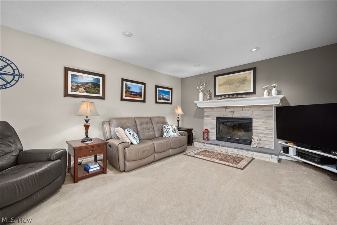 3270 North Ridge Road Vermilion, OH 44089 - Photo 20 of 49 Stone-clad fireplace with a classic mantel, recessed lighting, and carpeted flooring