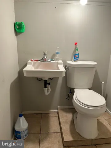 a bathroom with a sink toilet and a mirror