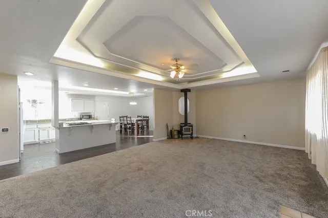 a view of an empty room with a kitchen