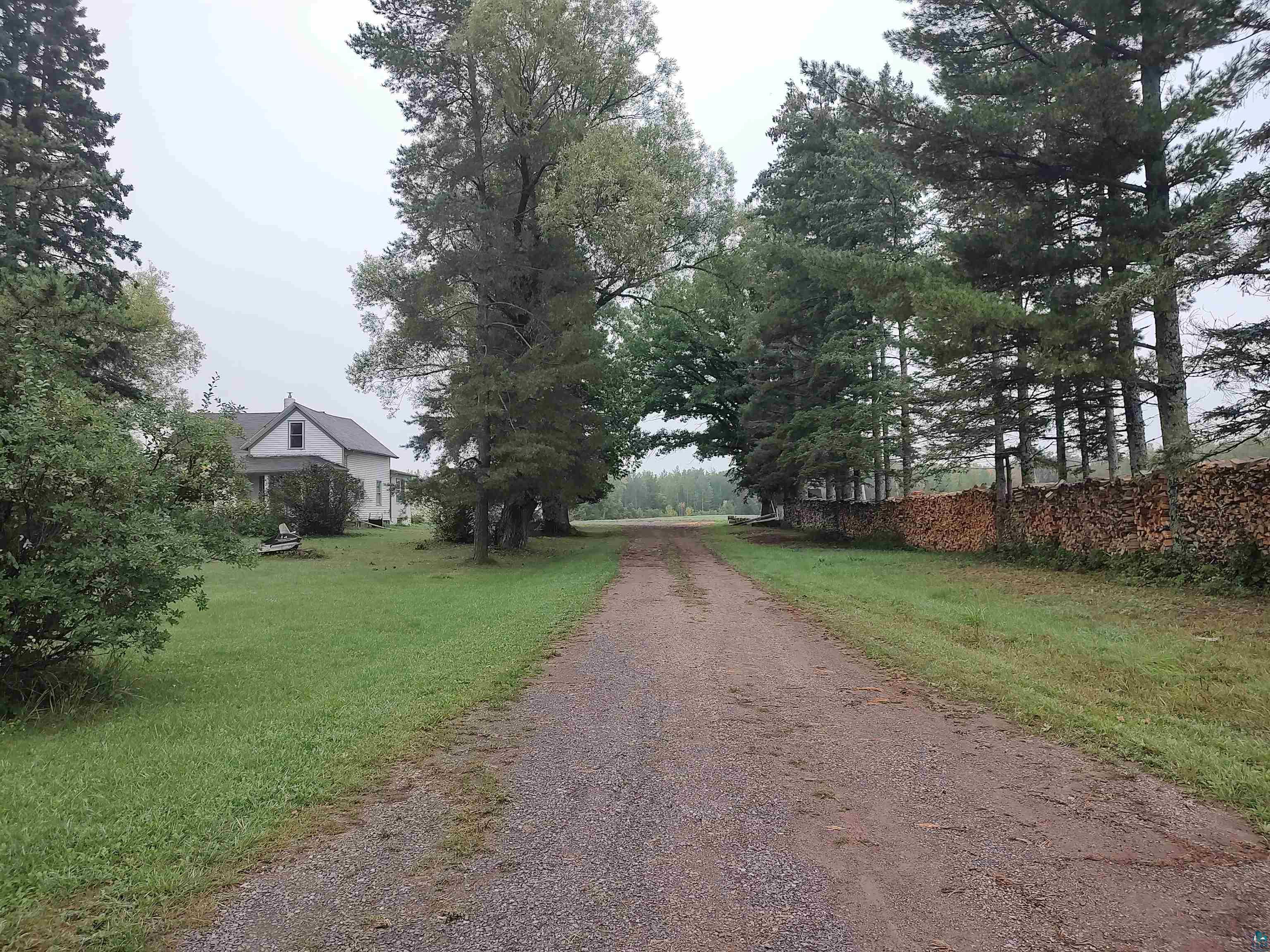 2585 Hautala Road Iron River, WI 54847 - Photo 1 of 28 Long gravel driveway flanked by mature trees and manicured lawn