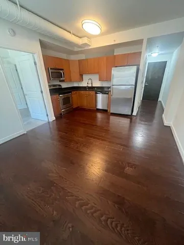 a view of a livingroom with furniture wooden floor and window