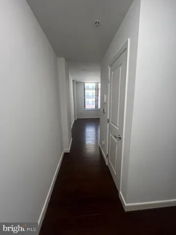 an empty room with wooden floor and closet