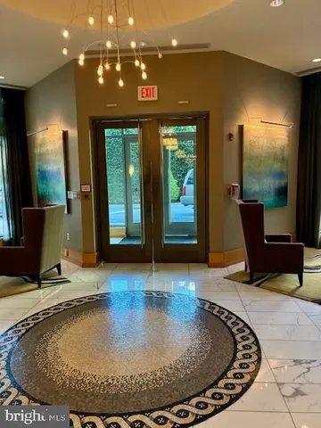 a living room with furniture and large windows