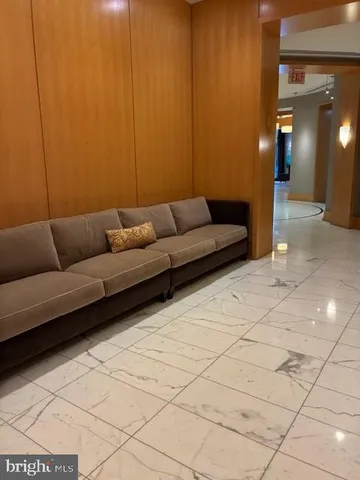 a view of a lobby with a chandelier and fireplace
