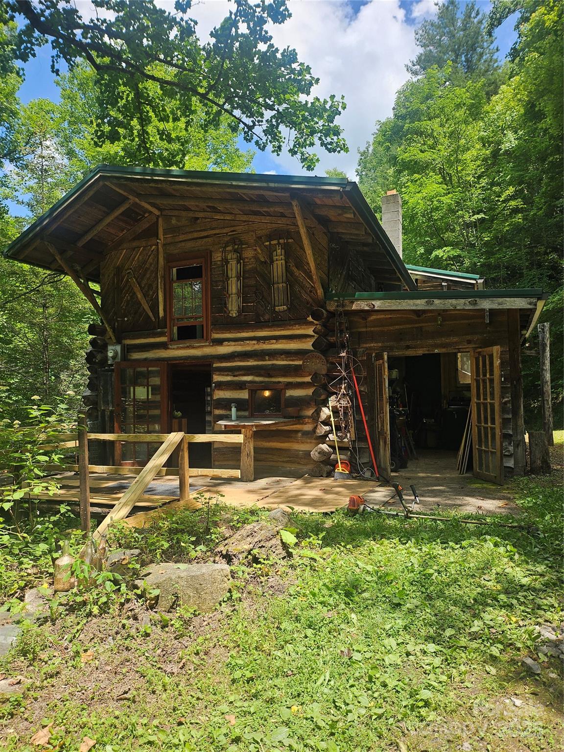 1710 Roaring Fork Road Mars Hill, NC 28754 - Photo 7 of 20 a backyard of a house with yard and outdoor seating