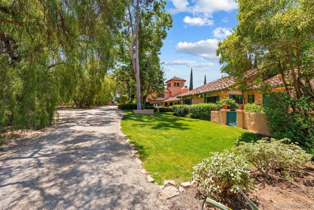 a view of street with houses and trees in the background