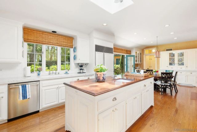 a kitchen with sink and view of living room
