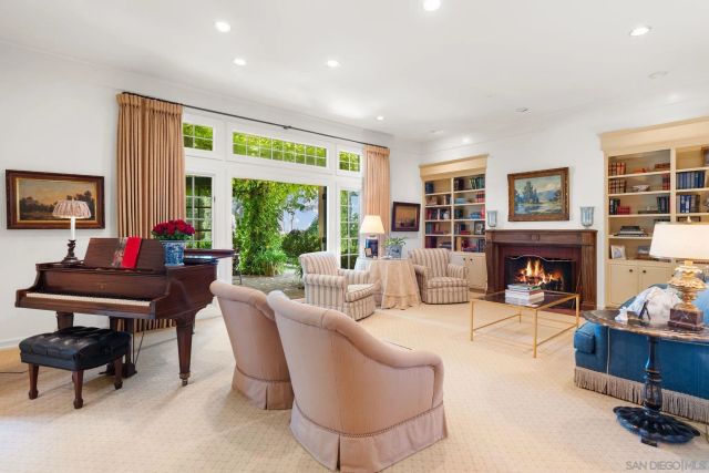 a living room with furniture fireplace and a large window