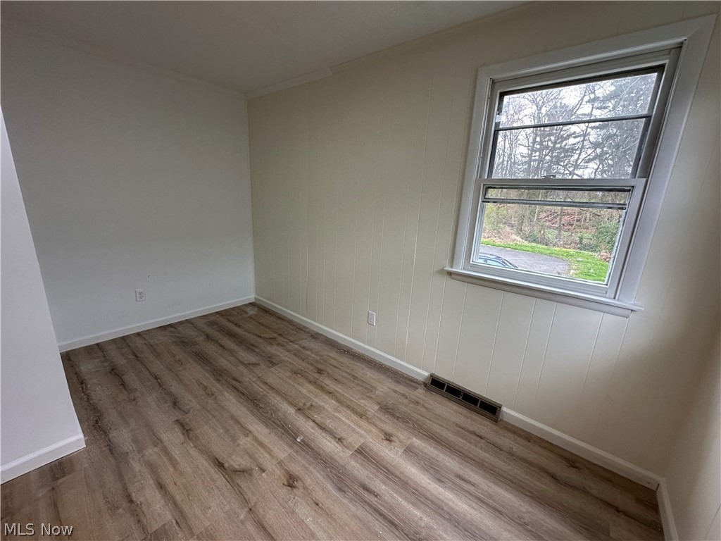 119 Shields Road, Unit 3 Youngstown, OH 44512 - Photo 3 of 12 Unfurnished room with wood finished floors and crown molding