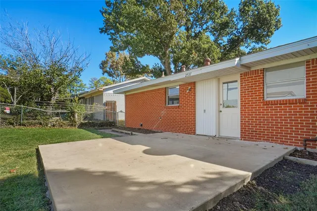 a view of a backyard with large trees