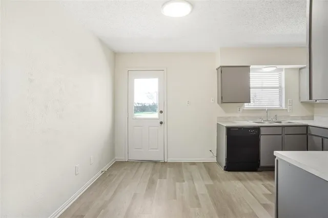 a view of a kitchen with a sink cabinets and a window