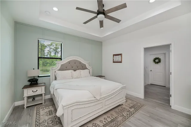 a bedroom with a bed and a painting on the wall