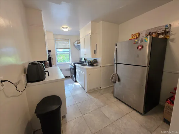 a kitchen with a refrigerator and a stove