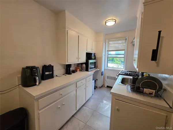 a kitchen with a sink and a stove top oven