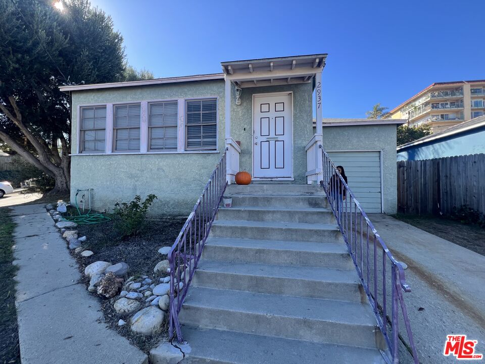 a view of a house with wooden floor and a fence