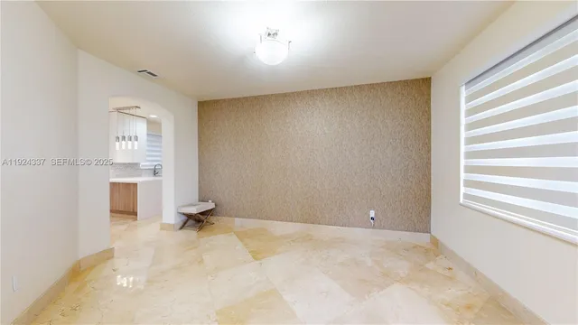 a view of kitchen with refrigerator and window