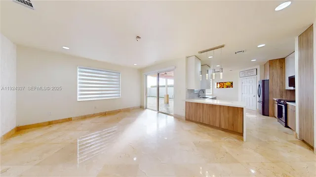 a large kitchen with a large counter top appliances and cabinets