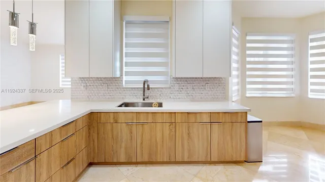 a kitchen with a refrigerator and a sink