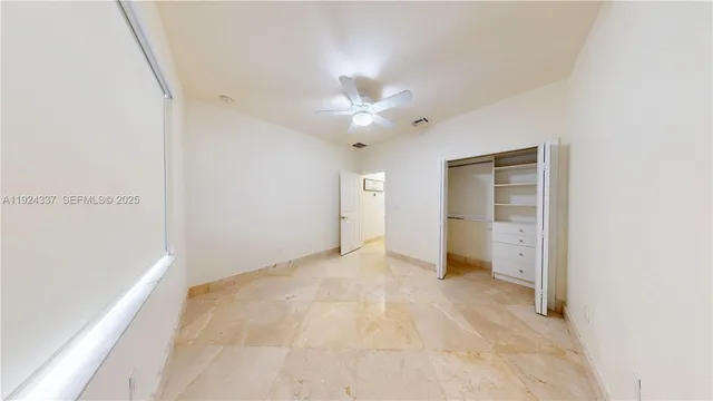 an empty room with closet and cabinet